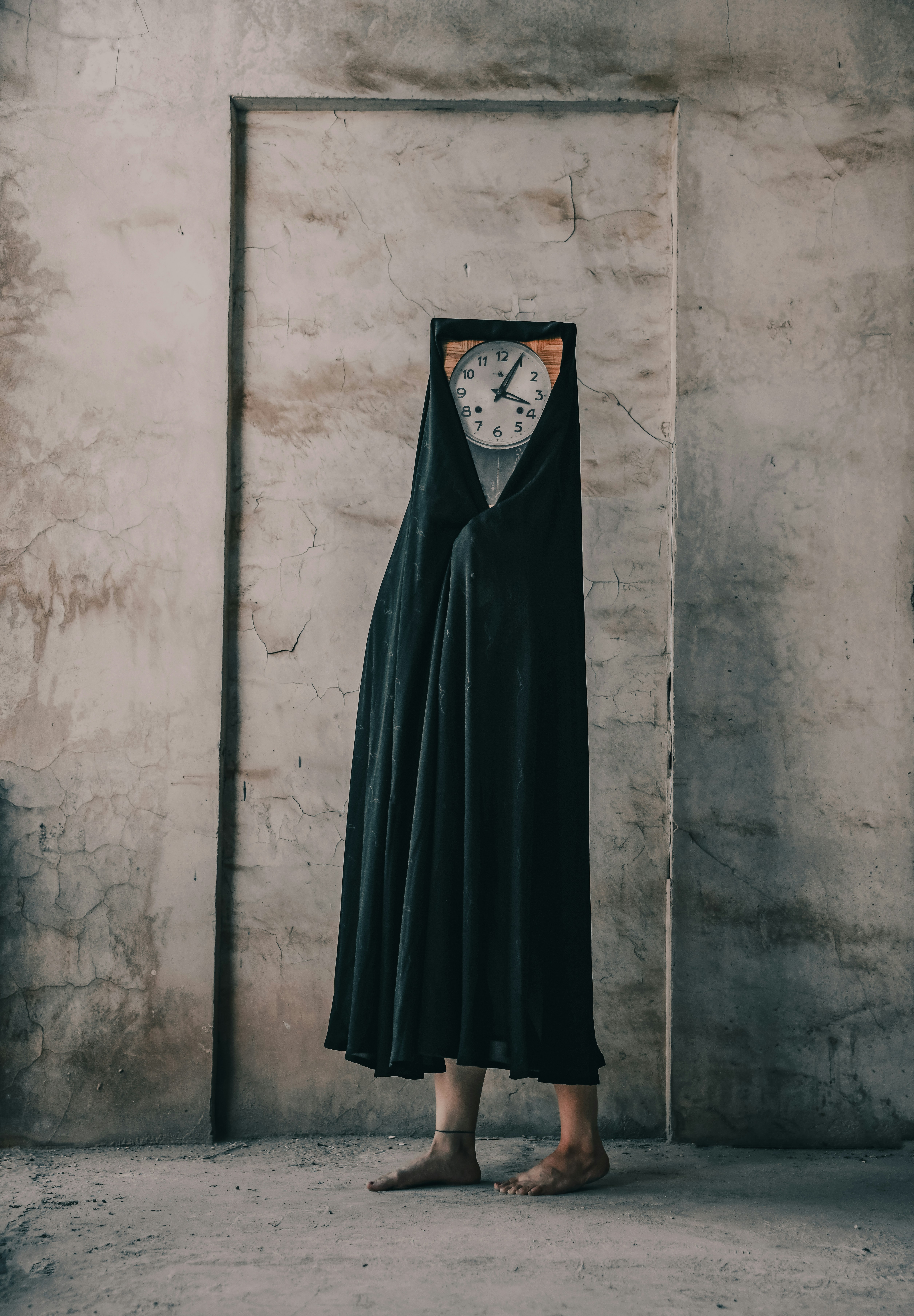 A draped figure with a clock for a face